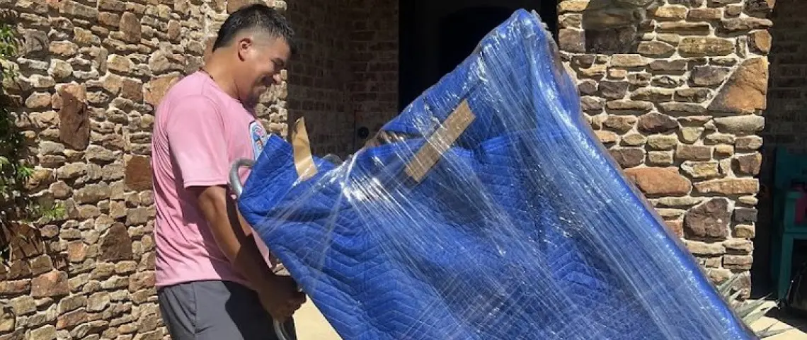 piggyback moving premium team member outside a house