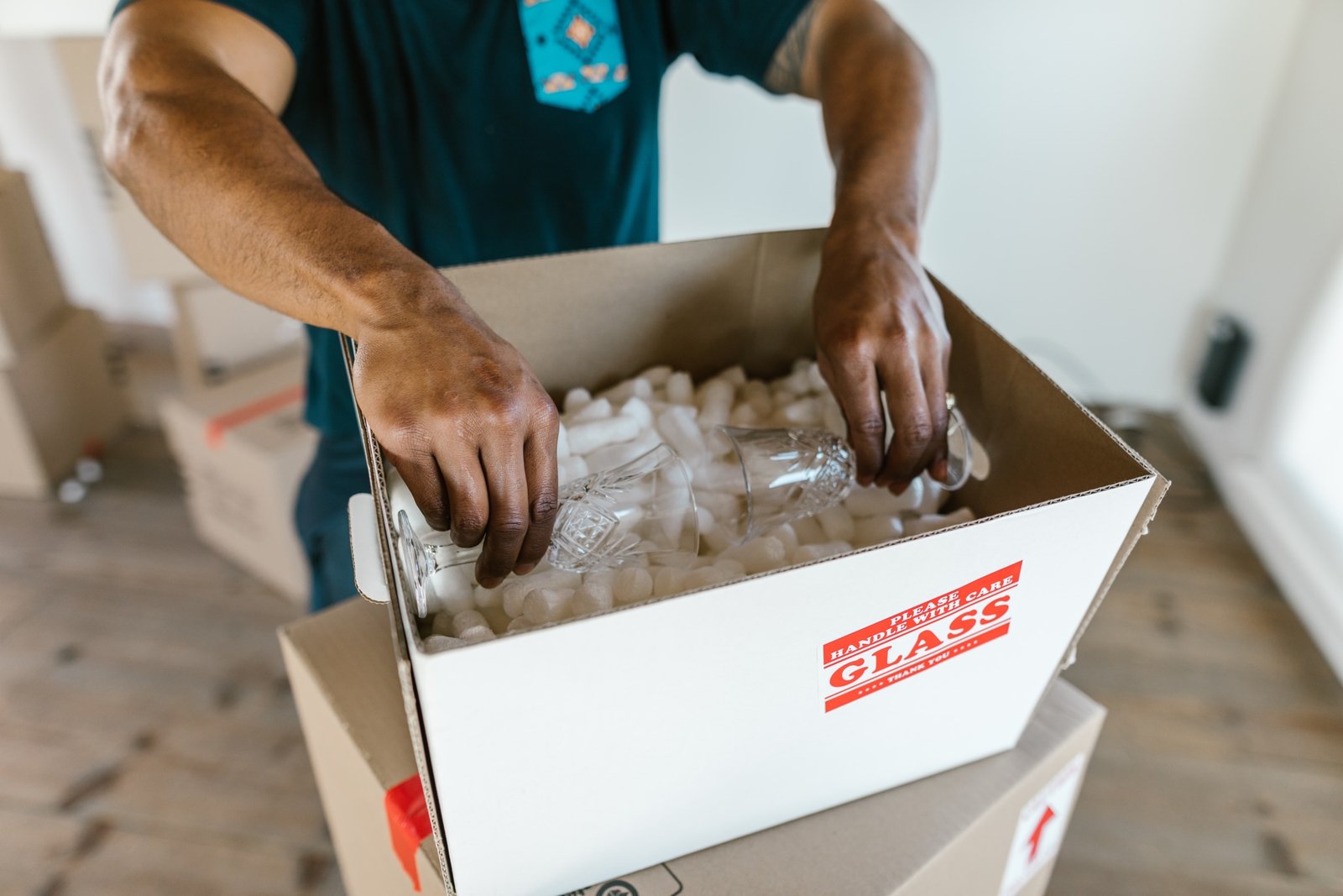 a man packing glasses
