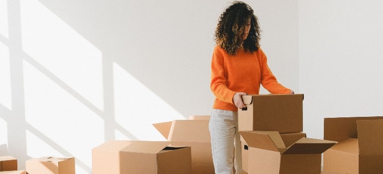 A woman packing boxes.